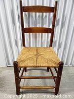 Front view of a dowel joined antique beechwood chair with a replaced rope seat in one of the two styles.