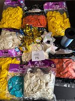 All bags of balloons, ribbon spool and weights