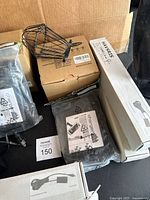 IKEA boxed light parts, wire cage shade, ChargerCity mounts and sealed pouches