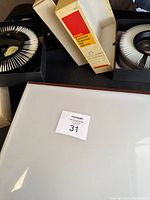 Two Kodak Carousel slide trays in black sleeves, Kodak storage boxes, Logan Tru View light box