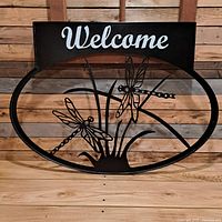 Front view showing complete sign with welcome text and dragonfly cutouts