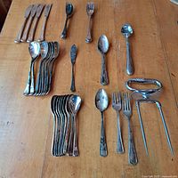all flatware pieces laid out on table