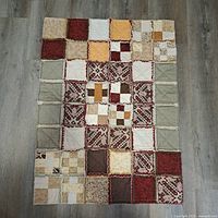 Front view of full quilt showing patchwork and rag seams