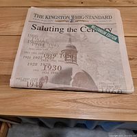 Newspaper folded on table showing full front page