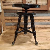 Full view of stool upright showing seat, legs and finish