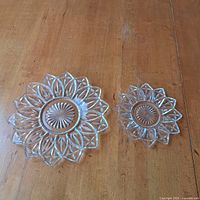 Large and small starburst pressed glass dishes side by side