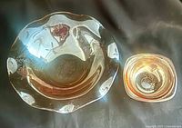 Both iridescent glass bowls side by side