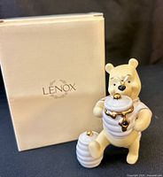 Front view of Lenox Winnie the Pooh figurine with honey pots and box