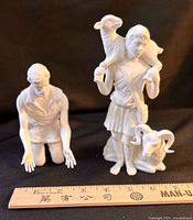 Both Lenox shepherd figurines with ruler for scale