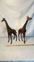 Both giraffe figurines side by side