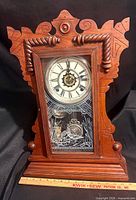 Front view showing carved oak case and etched glass door