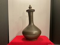 Full view of pottery vase with stopper in place