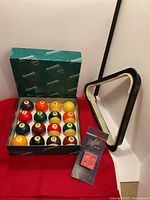 Full lot showing ball set in open box, triangle rack, and cue chalk pack