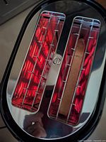 Top view showing glowing heating elements and bread slice in slot