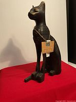 Full view of Egyptian cat statue with hang tag