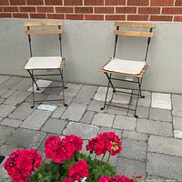 Front view of both folding chairs set on patio