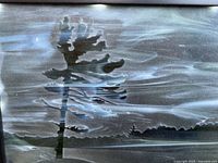 Close view of etched glass artwork showing windswept pine design