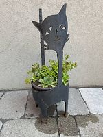 Full view of metal cat stand with planter and plants