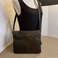 Purse on mannequin showing size, color blocking and strap length