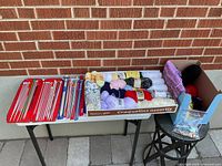 Full lot on table showing needles, yarn and box