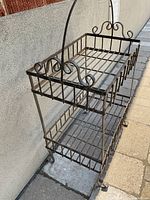 Front corner view of entire two-tier wrought iron stand