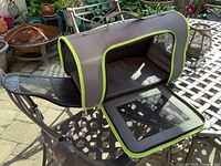 Carrier open on table showing mesh top flap and interior