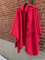 Front view of red fleece cape with scarf
