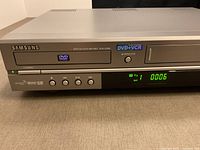 Front view of Samsung DVD-V2000 showing branding and controls