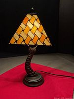 Full view of lamp lit, showing shade pattern and base