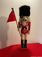 Front view of wooden nutcracker soldier with red flag