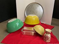 Overall view showing all six items: two inverted bowls, butter dish, small bowl, egg cup, round tray