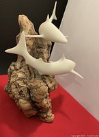 Front view of two resin sharks on burlwood base