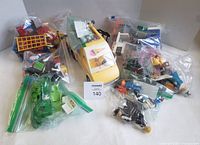 Overview of all bagged Playmobil pieces and loose figures around Ice Cream Truck vehicle