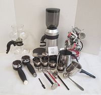 Full lot showing grinder, vacuum pot, barista tools, pitchers, thermometers, cups and stand