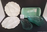 Full lot: two white scallop plates, green baking dish, stack of six green glass oyster plates