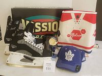 Full lot showing skates, box, cooler, stein, hat, bobblehead