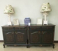 Front view of both cabinets with lamps, vase and frames displayed