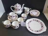Full set showing teapot, creamer, cups, saucers and dessert tray