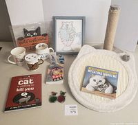 All items overview including scratchers, books, mugs, decor, sunglasses, air freshener