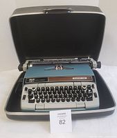 Typewriter seated in open hard shell case