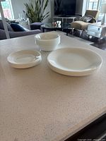 Photo of stacked small plates, large plates, and bowls showing the full set.