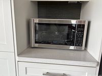Hamilton Beach microwave oven placed on kitchen countertop, showing overall exterior view and control panel.
