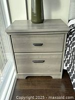 Front view of nightstand showing two drawers and grey wood-tone finish