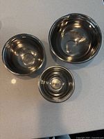 Top-down view of the three stainless steel mixing bowls, showing the interior and size difference.