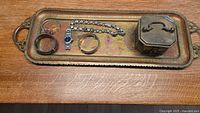 Tray, box, ring, watch, bangles and bracelet arranged on surface