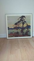 Front view of framed print showing the landscape scene with large tree, hills, and water, styled after Tom Thomson's The Jack Pine.