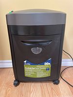 Front view of Royal 80X paper shredder showing brand, model, shred type, and capacity details on label affixed to front panel.
