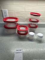 All Rubbermaid containers with lids stacked and grouped on countertop showing set composition and lid colors.