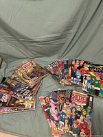 Wide view of the comic lot showing multiple stacks of DC Justice League comics in plastic sleeves with colorful hero covers.