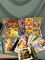 Full lot of 26 Liberty Meadows comic books arranged in two rows on a blue surface, showing colorful illustrated covers with various characters.